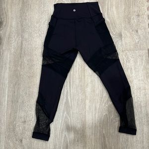 Lululemon leggings with pockets and mesh detailing on legs. Black. Size 8